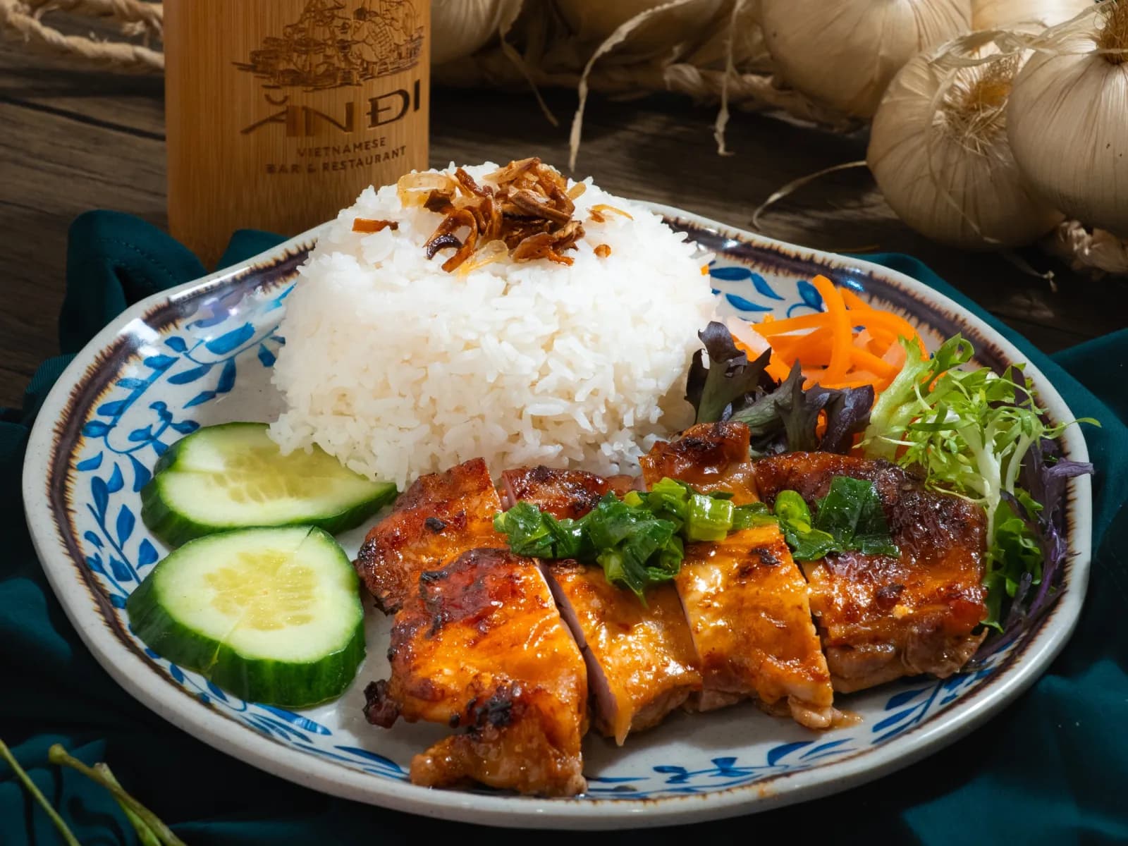 Char-grilled chicken on steamed rice with cucumber and pickled carrot