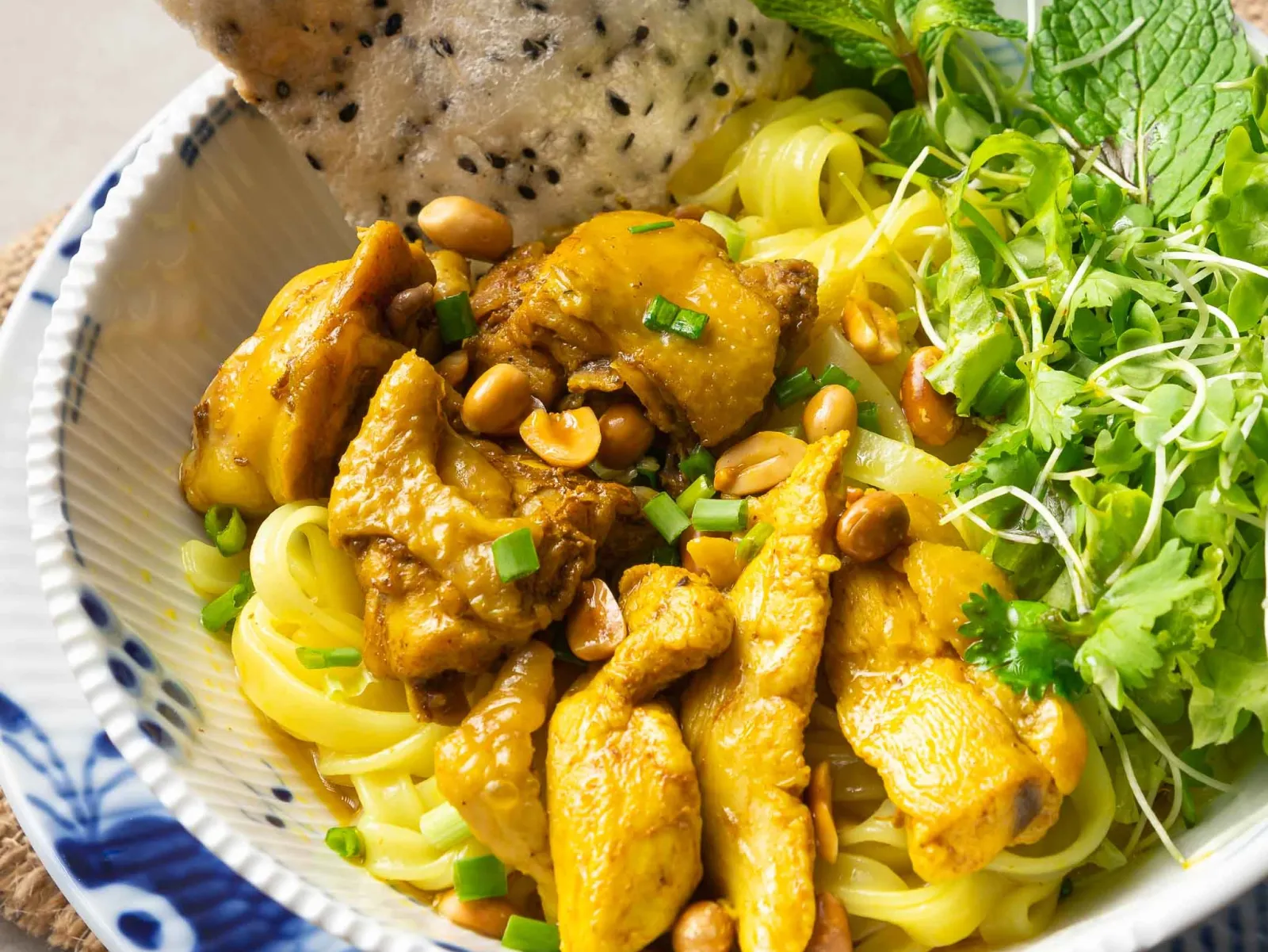 Mì Quảng yellow noodles with chicken, peanuts and fresh herbs