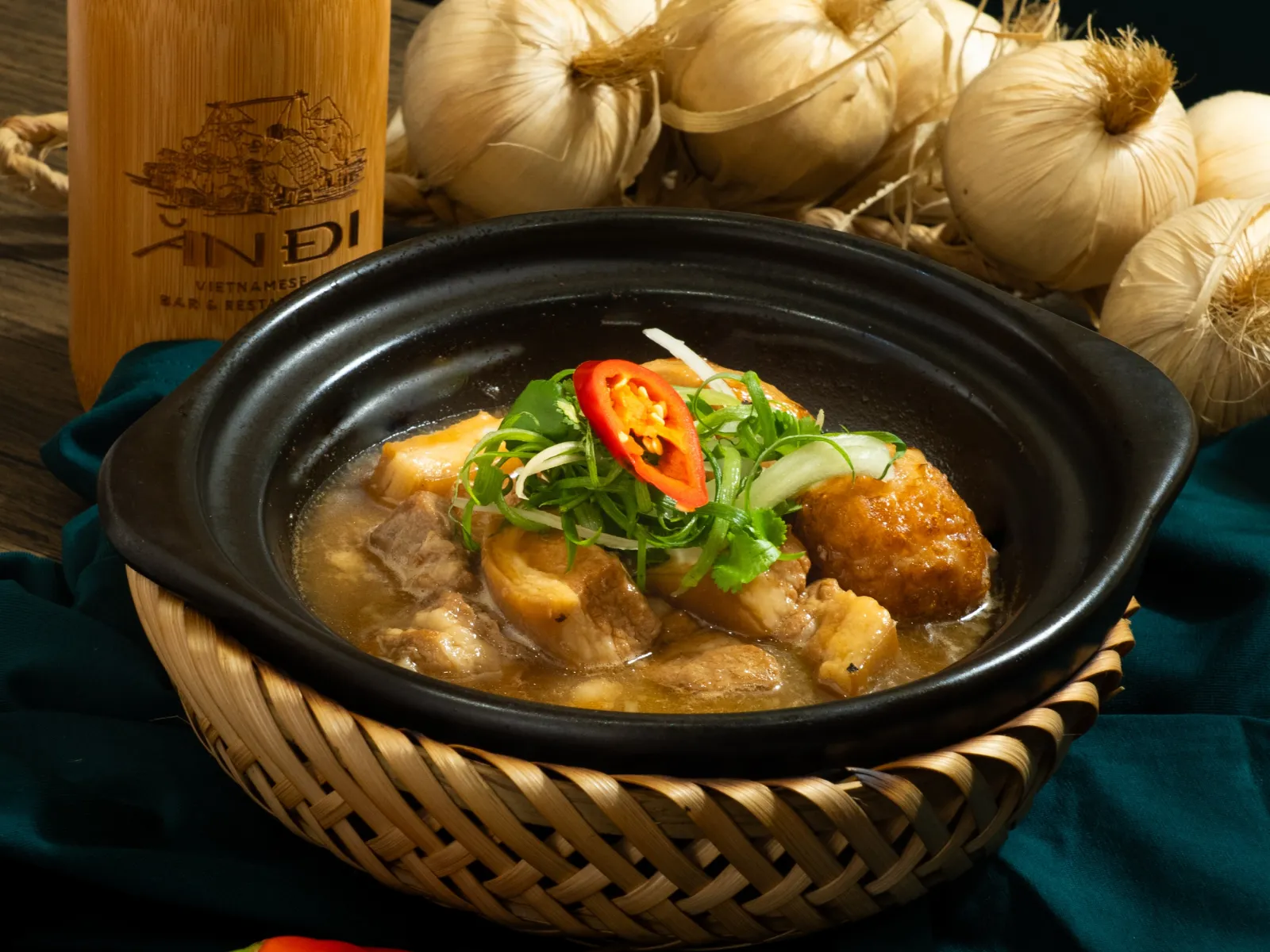 Thịt kho trứng, braised pork belly and egg in a black clay pot