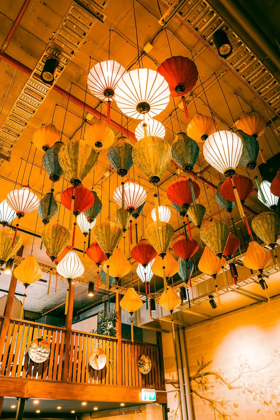 Silk lanterns hanging from the ceiling above the mezzanine at ĂN ĐI